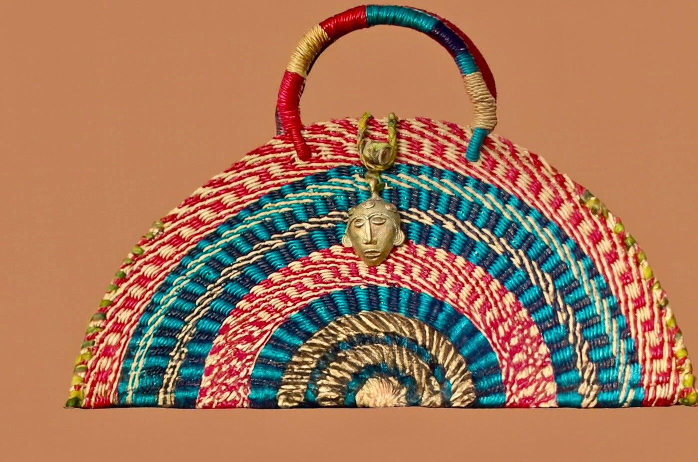 Handwoven Half-Moon Bag with Brass Mask Pendant