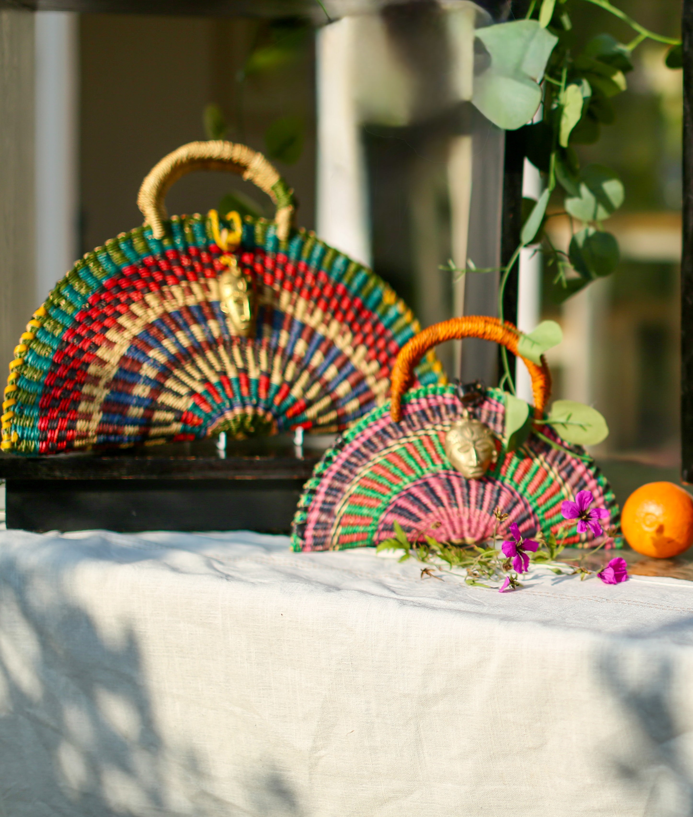 Radiant Half-Moon Handwoven Bag with Brass Mask Charm