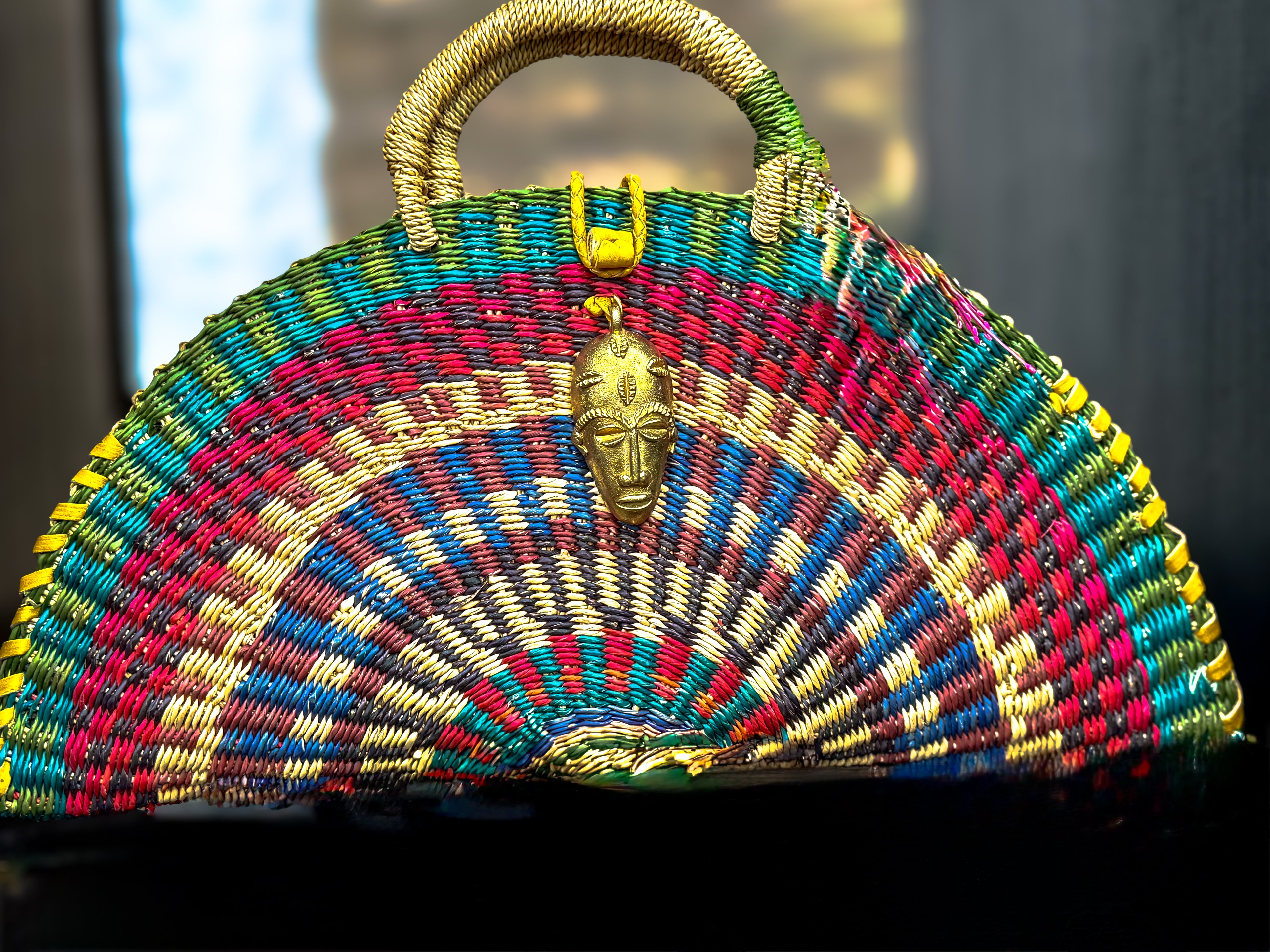 Radiant Half-Moon Handwoven Bag with Brass Mask Charm